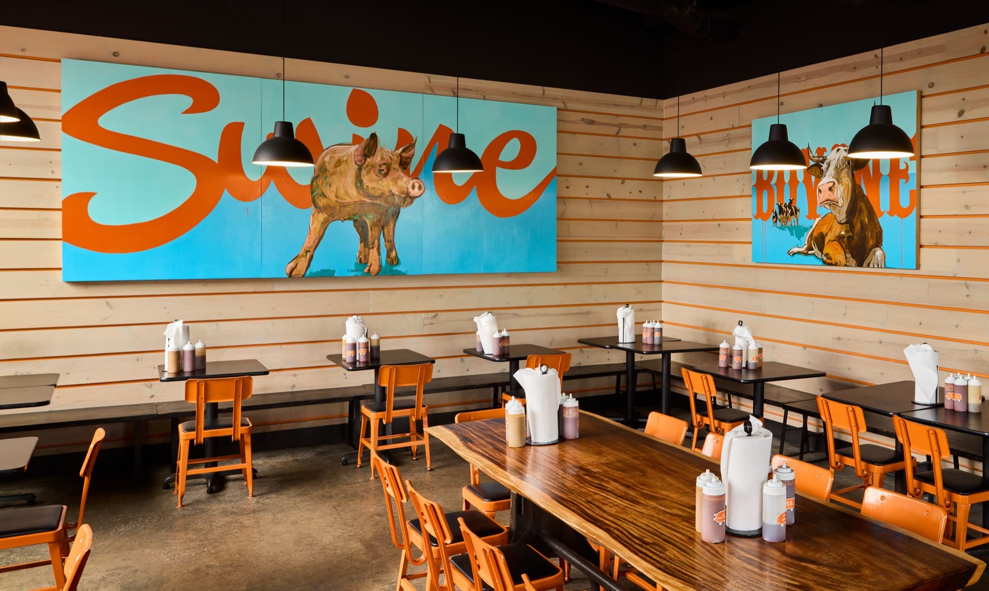 The Bearded Pig dining room with the orange Swine mural